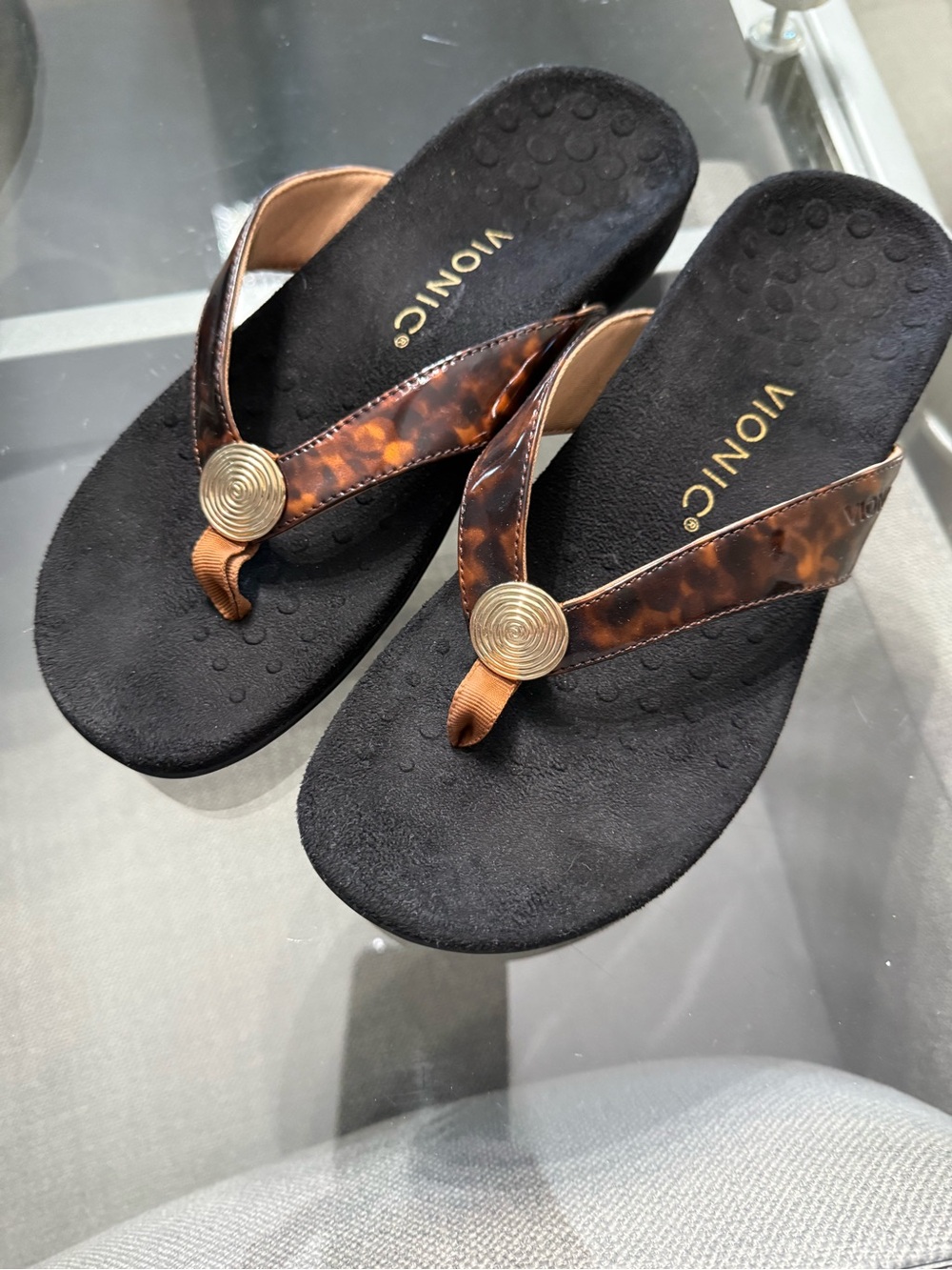 Vionic Black Sandal with Tortoise-Print Straps and Gold Medallion
